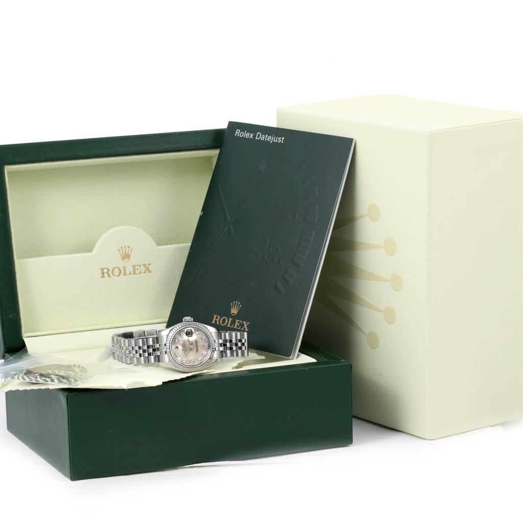 The image shows a Rolex Datejust 179174 Women
s Stainless Steel Mother of Pearl Dial 179174 Women
s Stainless Steel Mother of Pearl Dial watch from a front angle, placed inside its open box, with accompanying booklet and accessories.