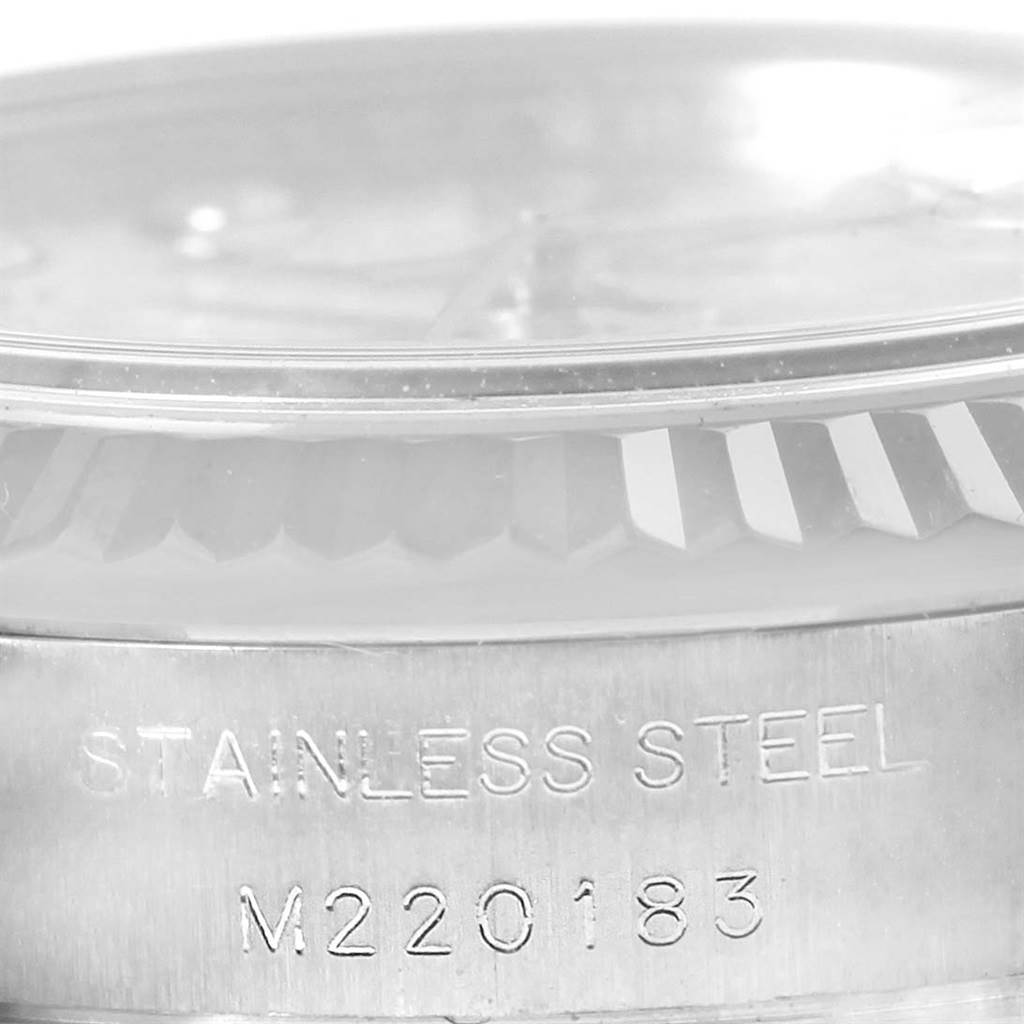 The image shows a close-up of the side of a Rolex Datejust 179174 Women's Stainless Steel Blue Dial 179174 Women's Stainless Steel Blue Dial model, focusing on the stainless steel case with engraved serial numbers.