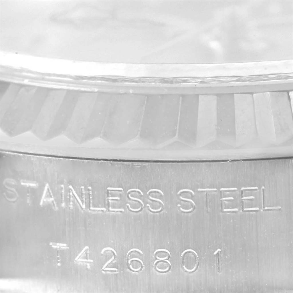 The image shows a close-up of the stainless steel casing and fluted bezel of a Rolex Datejust 69174 Women
s Stainless Steel Pink Dial 69174 Women
s Stainless Steel Pink Dial watch.