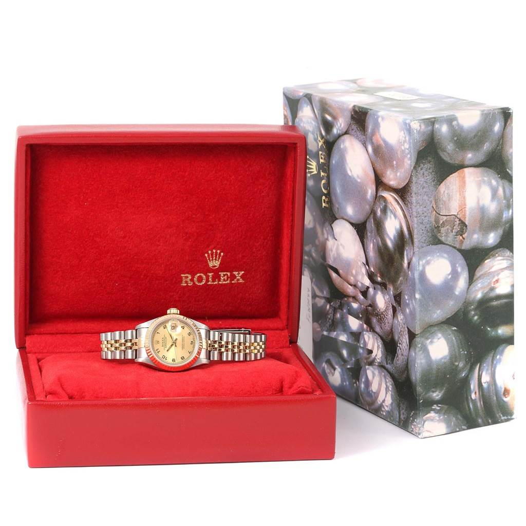 The Rolex Datejust 69173 Women's Stainless Steel Champagne Dial 69173 Women's Stainless Steel Champagne Dial watch is shown from the front, displayed inside a red box with a decorative outer box on the right.