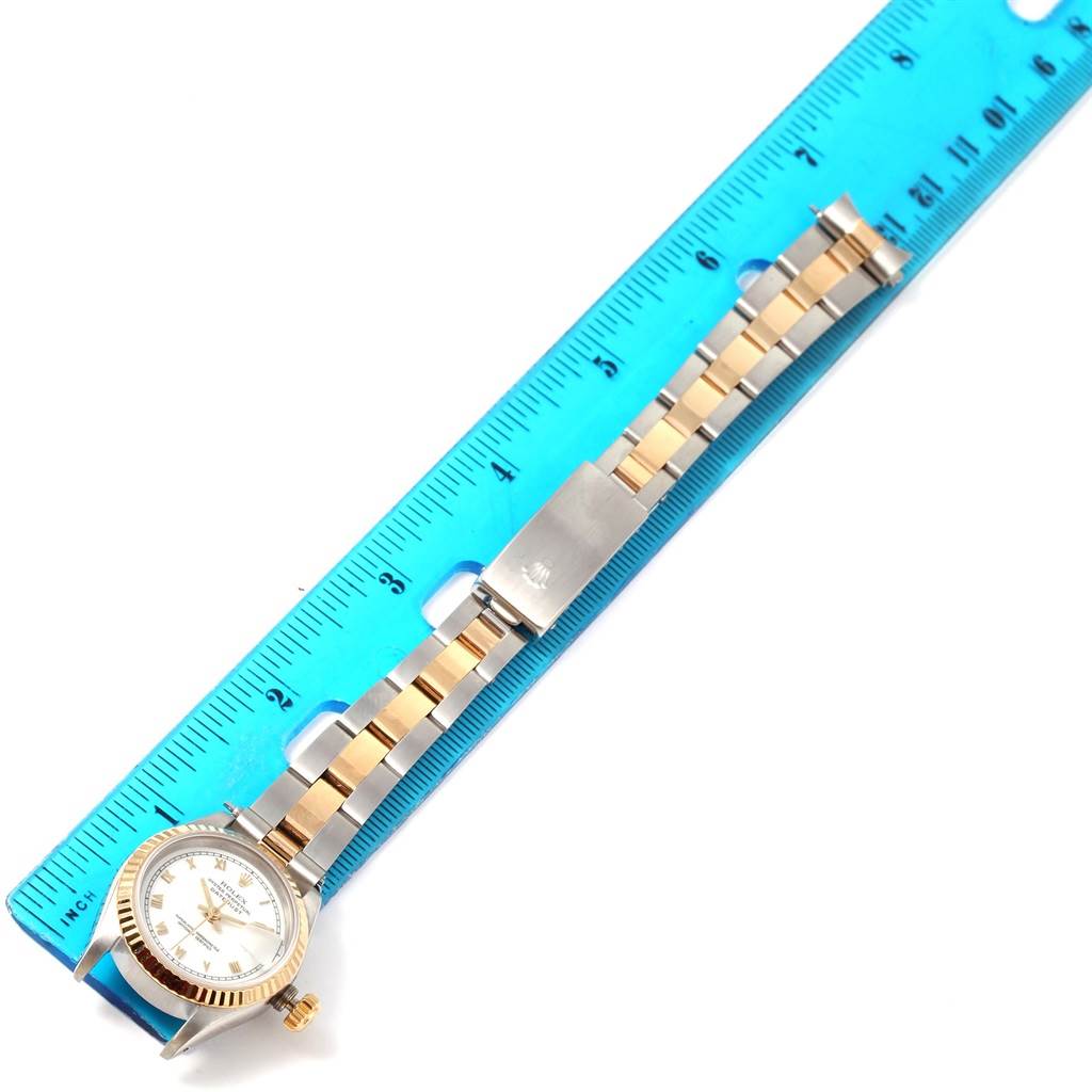 The image shows a top-down view of a Rolex Datejust 69173 Women's Stainless Steel White Dial 69173 Women's Stainless Steel White Dial watch, featuring its entire band and face laid next to a blue ruler.