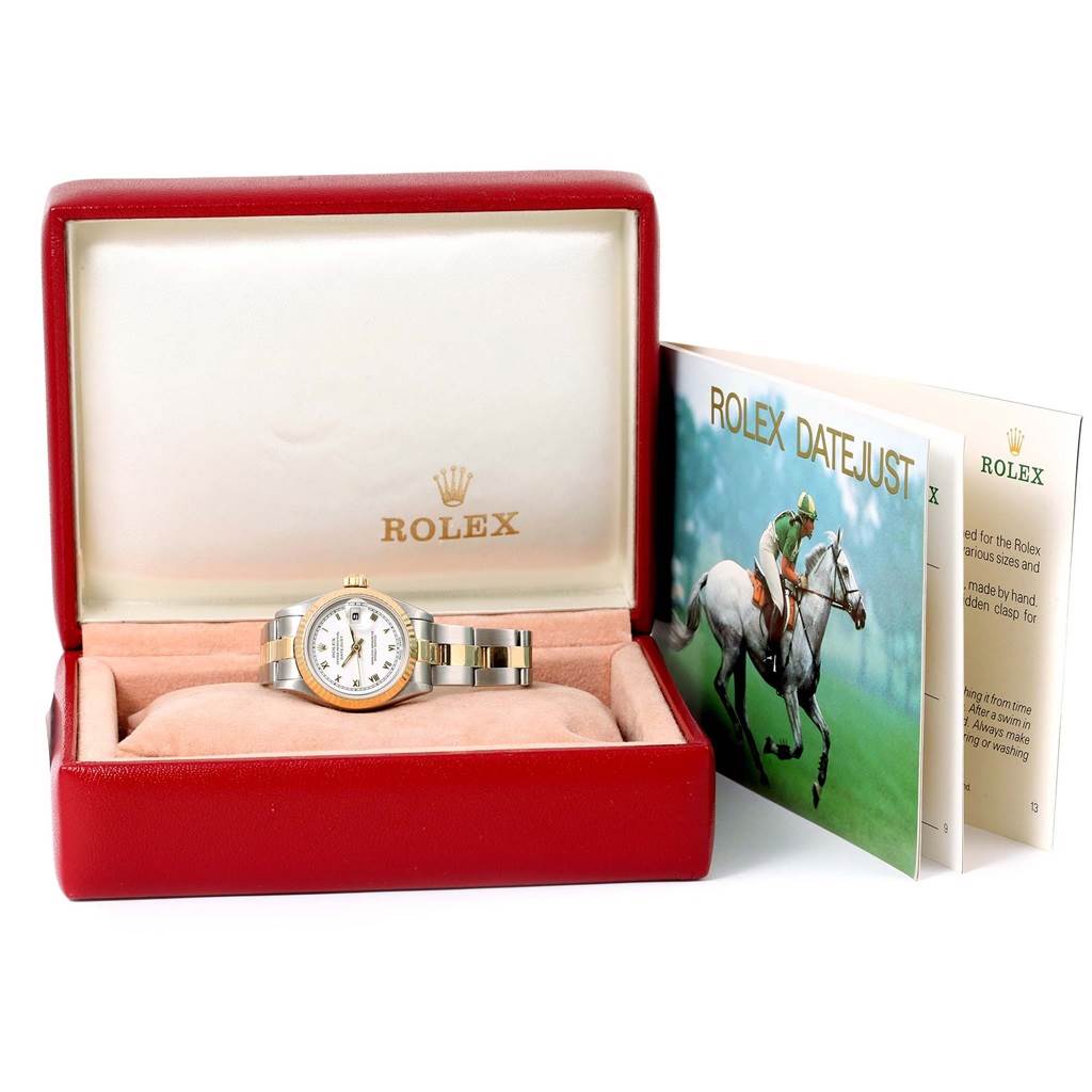 The image shows a Rolex Datejust 69173 Women's Stainless Steel White Dial 69173 Women's Stainless Steel White Dial watch in its box, with the watch and its band visible, along with accompanying booklets.
