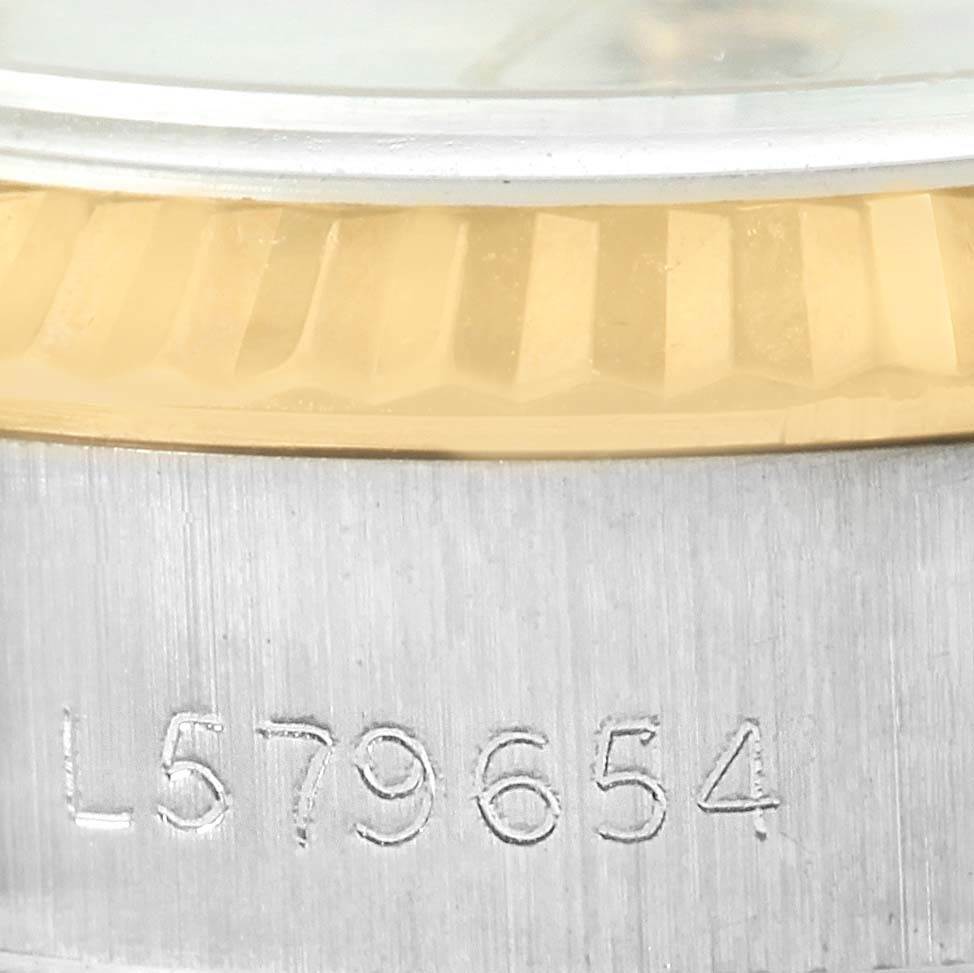 The image shows a close-up of the serial number and fluted bezel on a Rolex Datejust 69173 Women's Stainless Steel White Dial 69173 Women's Stainless Steel White Dial watch.