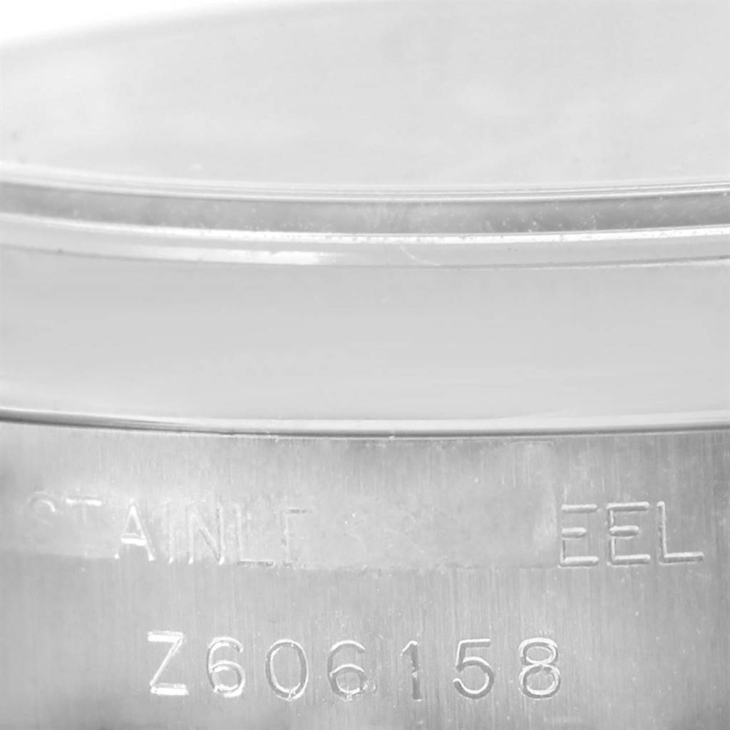 This image shows a close-up of the side of the Rolex Datejust 179160 Women's Stainless Steel Pink Dial 179160 Women's Stainless Steel Pink Dial watch case with engraved serial numbers.
