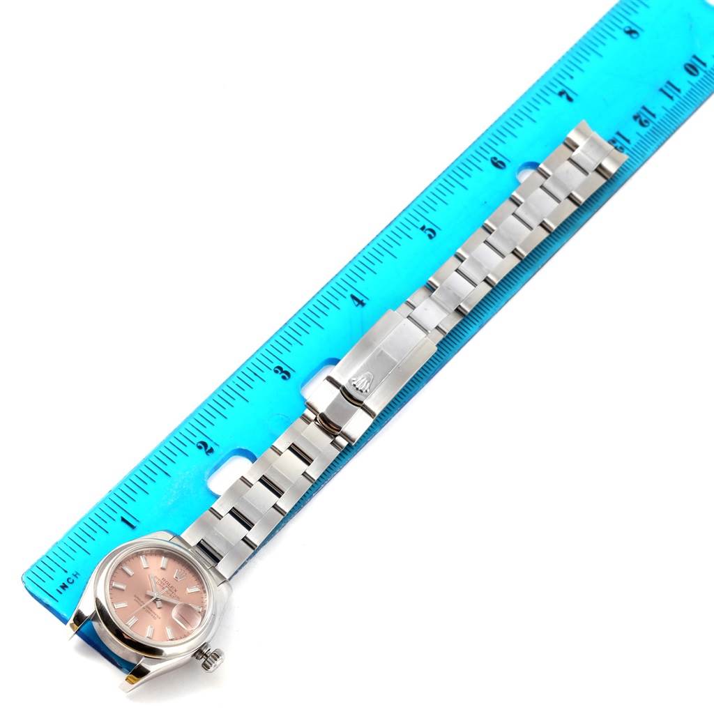 The image shows a Rolex Datejust 179160 Women's Stainless Steel Pink Dial 179160 Women's Stainless Steel Pink Dial watch with a stainless steel bracelet and pink dial, measured against a blue ruler.