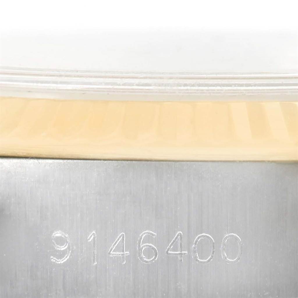 The image shows a close-up of the serial number on the metal case edge of a Rolex Datejust 69173 Women
s Stainless Steel Champagne Dial 69173 Women
s Stainless Steel Champagne Dial watch.