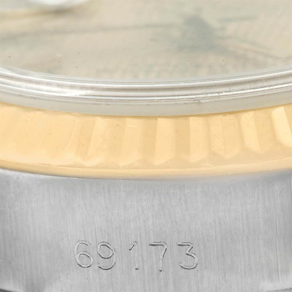 The image shows a close-up of the side view of a Rolex Datejust 69173 Women
s Stainless Steel Champagne Dial 69173 Women
s Stainless Steel Champagne Dial watch, highlighting the bezel and part of the case with the model number 69173 engraved.
