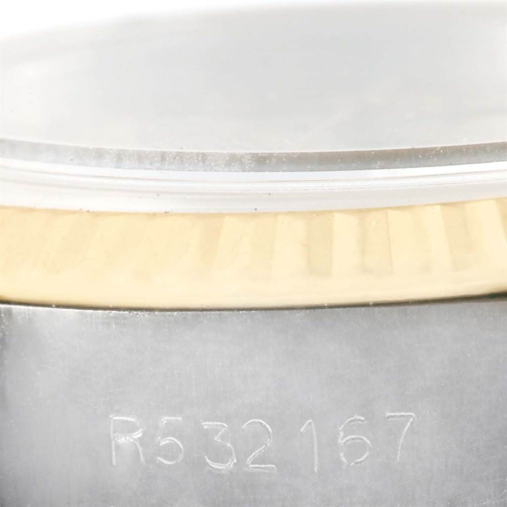 The image shows a close-up angle of the Rolex Datejust 69173 Women's Stainless Steel Champagne Dial 69173 Women's Stainless Steel Champagne Dial watch focusing on the serial number and part of the case and bezel.