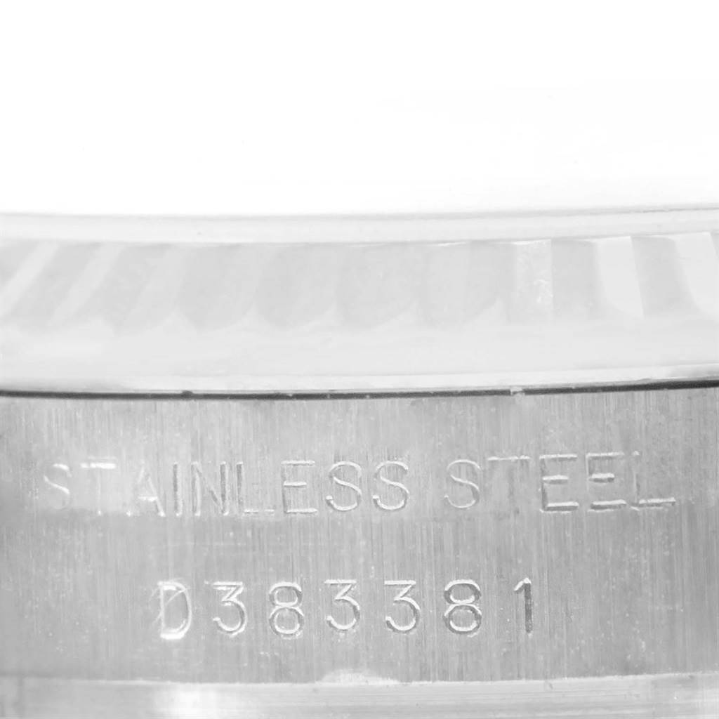 The image shows a close-up of the serial number and stainless steel inscription on a Rolex Datejust 179174 Women
s Stainless Steel White Dial 179174 Women
s Stainless Steel White Dial watch.