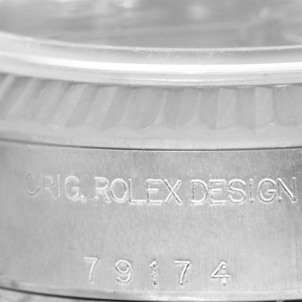 The image shows a close-up angle of the side engraving on a Rolex Datejust 79174 Women's Stainless Steel Mother of Pearl Dial 79174 Women's Stainless Steel Mother of Pearl Dial, featuring "ORIG. ROLEX DESIGN" and the number "79174."