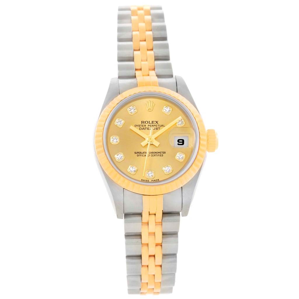 The Datejust Rolex watch is shown from a top-down angle, displaying its two-tone bracelet, gold dial, fluted bezel, and date window at 3 o'clock.