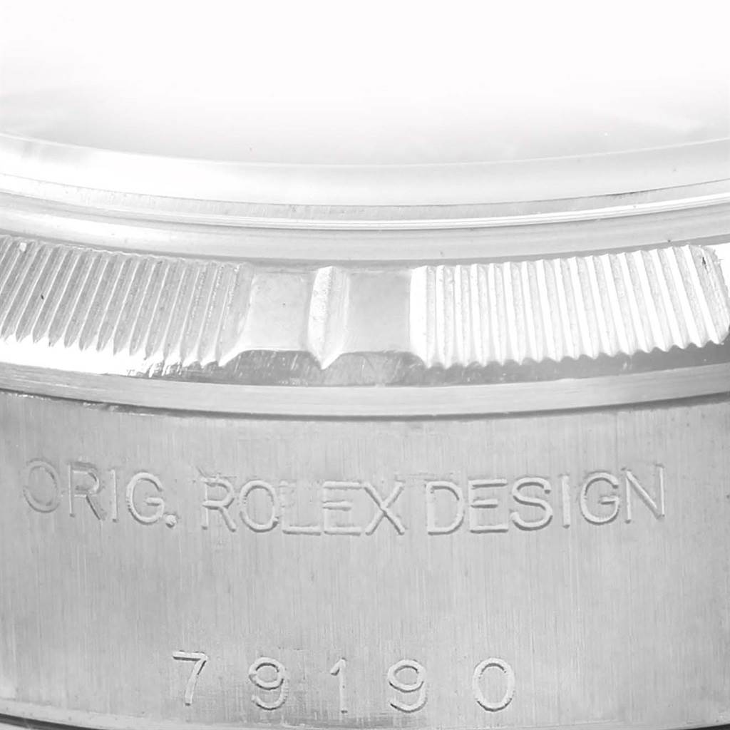 This image shows a close-up angle of the bezel and case of the Rolex Datejust 79190 Women's Stainless Steel Black Dial 79190 Women's Stainless Steel Black Dial, displaying the inscription "ORIG. ROLEX DESIGN" and the model number.