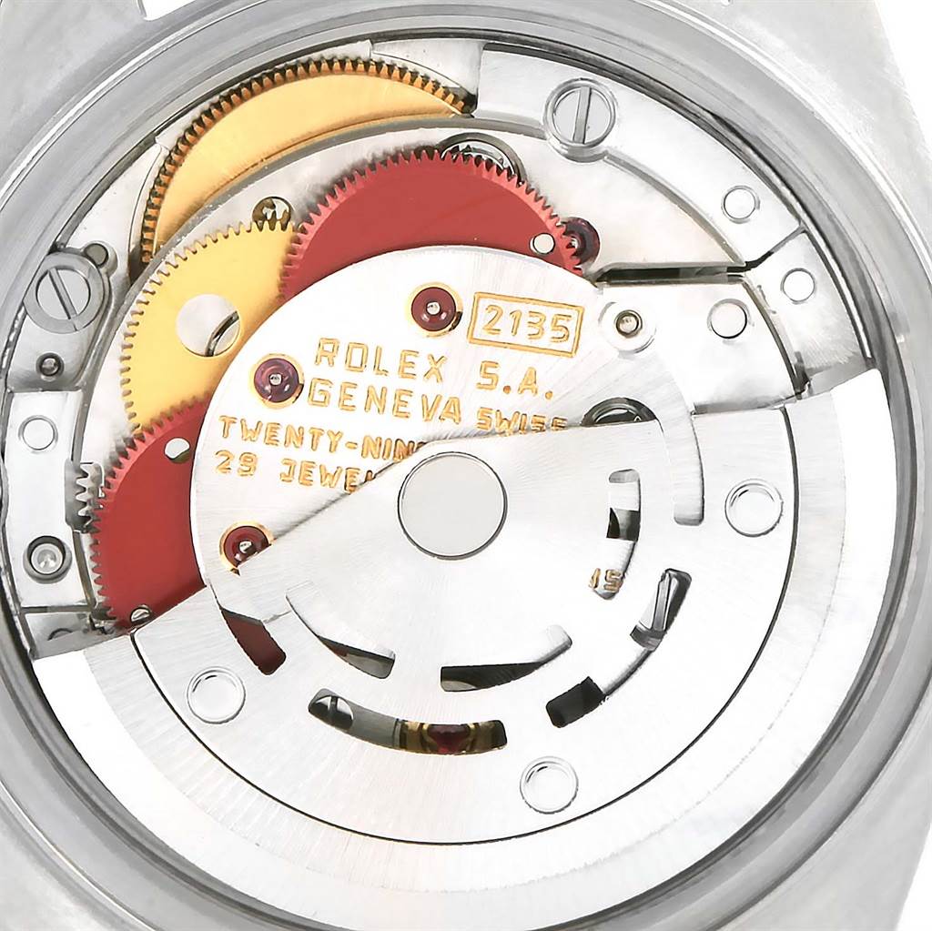The image shows the intricate internal mechanism of a Rolex Datejust 69173 Women's Stainless Steel Grey Dial 69173 Women's Stainless Steel Grey Dial watch, highlighting gears and the rotor.