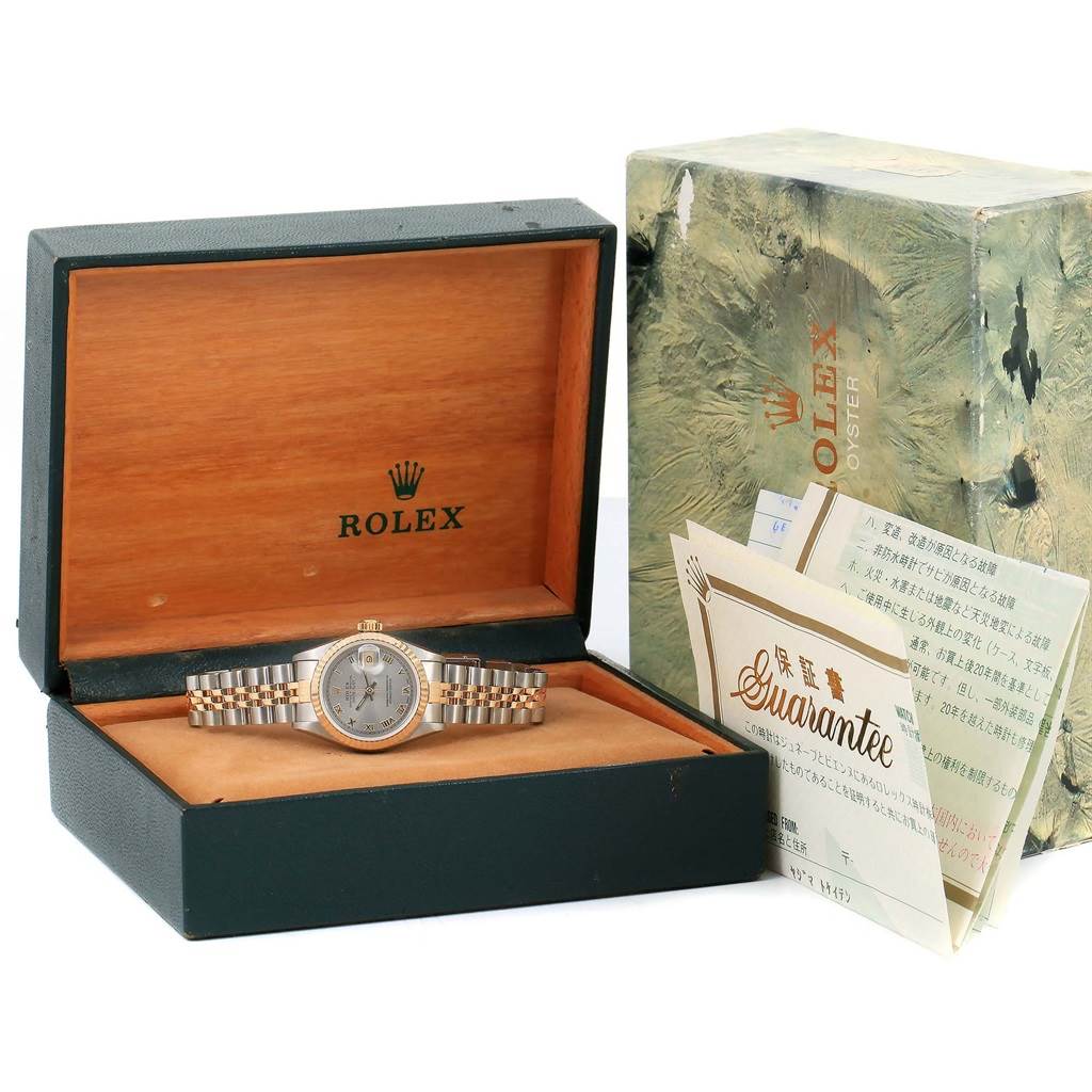 The Rolex Datejust 69173 Women's Stainless Steel Grey Dial 69173 Women's Stainless Steel Grey Dial watch is shown inside its open box along with warranty papers and original packaging.