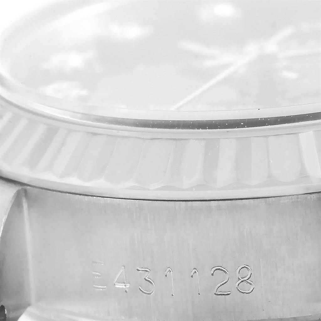 This close-up image displays the serial number and part of the bezel of a Rolex 69174 Men
s Stainless Steel Black Dial 69174 Men
s Stainless Steel Black Dial Datejust Ladies Steel White Gold Diamond Watch 69174 Box model.