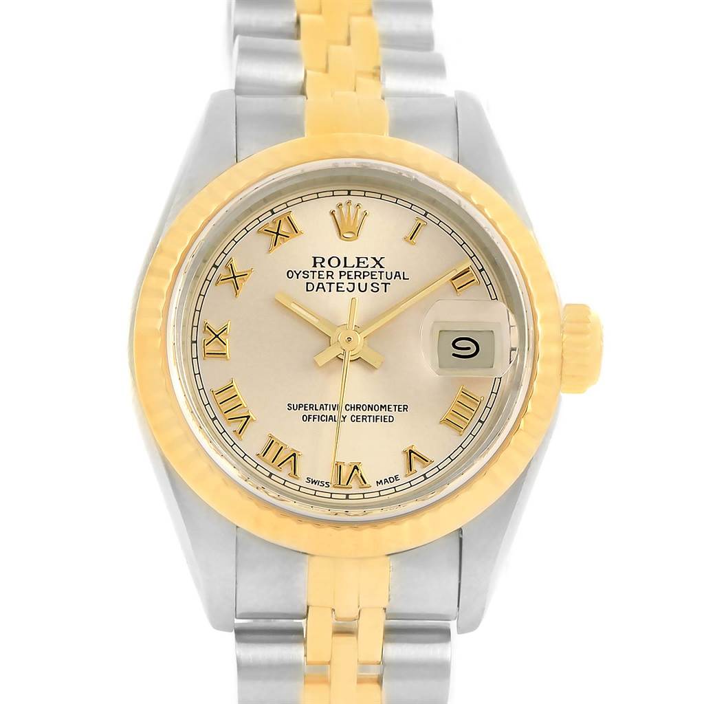 The image shows a frontal view of a Rolex Datejust 69173 Women
s Stainless Steel Champagne Dial 69173 Women
s Stainless Steel Champagne Dial watch featuring a gold bezel, silver and gold bracelet, and gold Roman numeral markers.