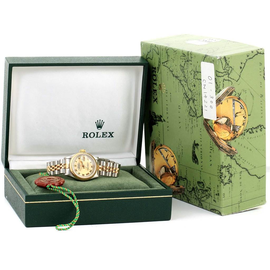 This image shows a Rolex Datejust 69173 Women
s Stainless Steel Champagne Dial 69173 Women
s Stainless Steel Champagne Dial watch in its opened green box, with the outer box and tag accessory visible.