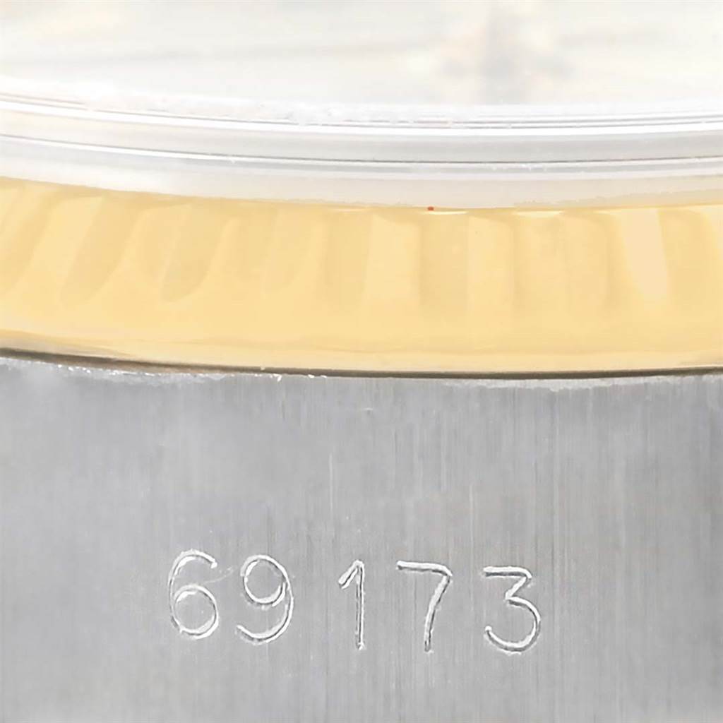 The image shows a close-up of a Rolex Datejust 69173 Women
s Stainless Steel Champagne Dial 69173 Women
s Stainless Steel Champagne Dial watch case with the reference number 69173 engraved on it.