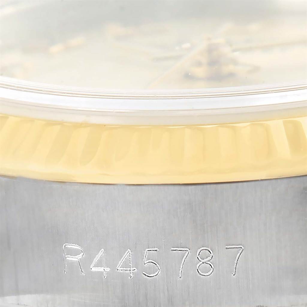The image shows a close-up of the serial number engraved on the side of a Rolex Datejust 69173 Women
s Stainless Steel Champagne Dial 69173 Women
s Stainless Steel Champagne Dial watch, featuring part of the bezel and crystal.