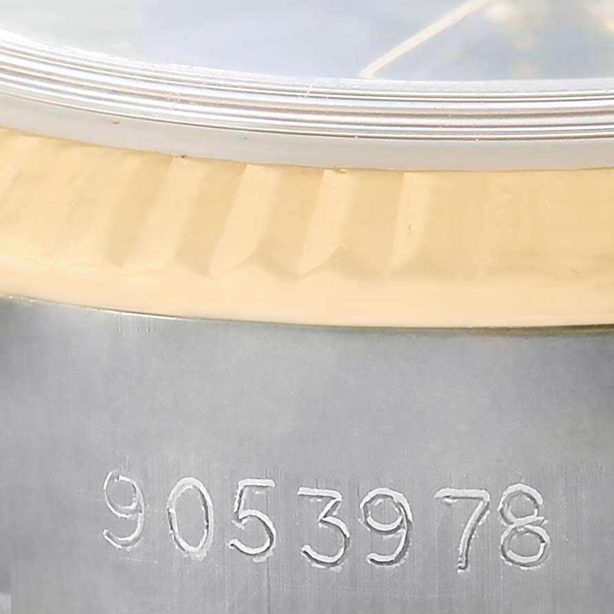 The image shows a close-up of the side of a Rolex Datejust 69173 Women's Stainless Steel Black Dial 69173 Women's Stainless Steel Black Dial watch, highlighting the serial number and part of the fluted bezel.