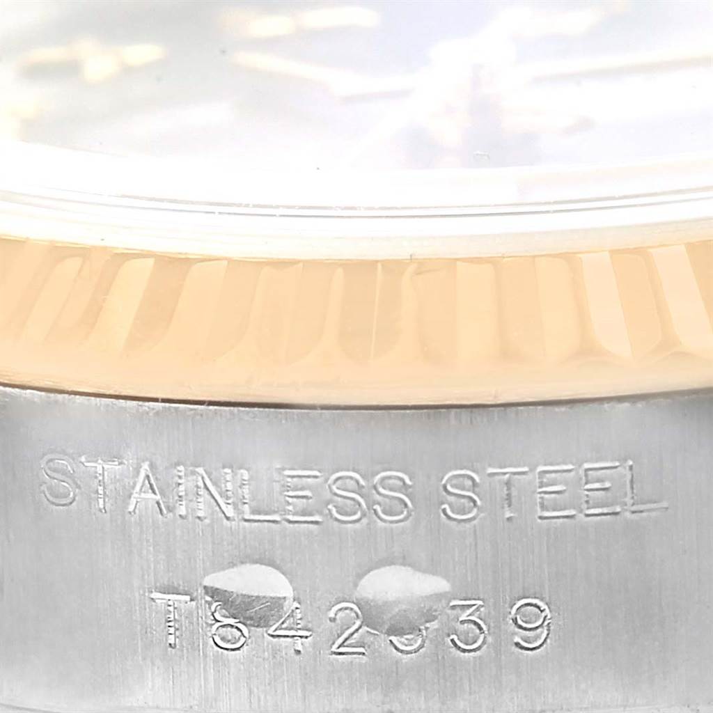 The image shows a close-up of the stainless steel case and part of the fluted bezel of a Rolex Datejust 69173 Women
s Stainless Steel Grey Dial 69173 Women
s Stainless Steel Grey Dial watch.