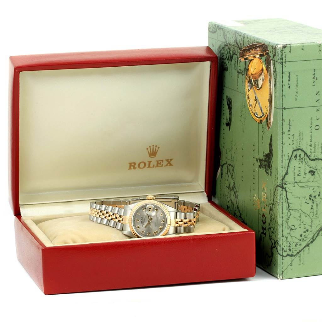 The Rolex Datejust 69173 Women
s Stainless Steel Grey Dial 69173 Women
s Stainless Steel Grey Dial watch is displayed in an open red box, with the green outer box positioned beside it.