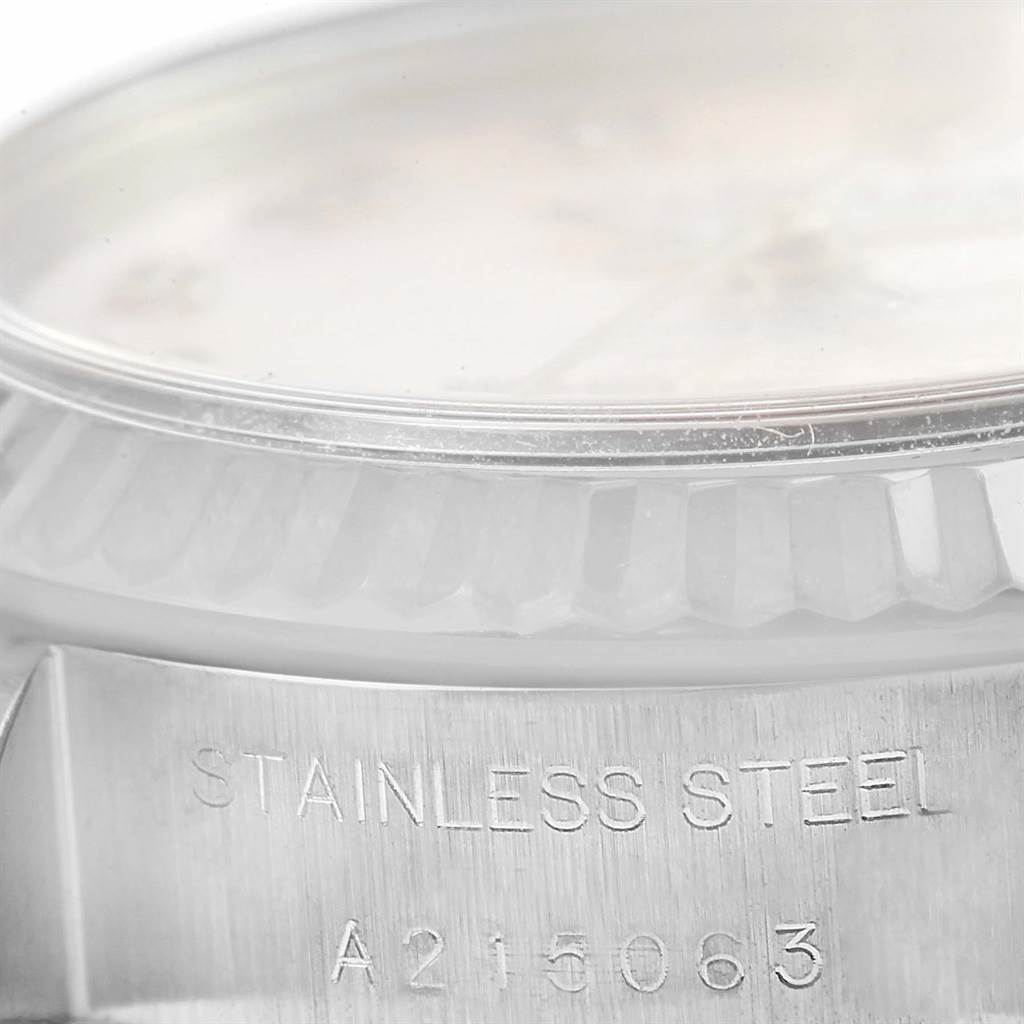 This image shows a close-up of the case and bezel of the Rolex Datejust 79174 Women's Stainless Steel Mother of Pearl Dial 79174 Women's Stainless Steel Mother of Pearl Dial model, focusing on the "STAINLESS STEEL" engraving.