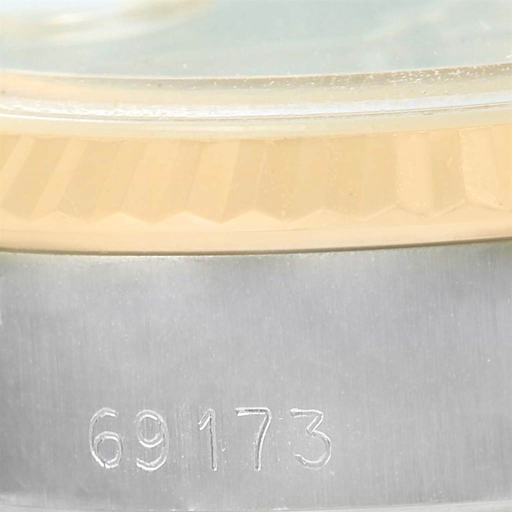 The image shows a close-up of the serial number and fluted bezel on a Rolex Datejust 69173 Women's Stainless Steel Champagne Dial 69173 Women's Stainless Steel Champagne Dial watch.
