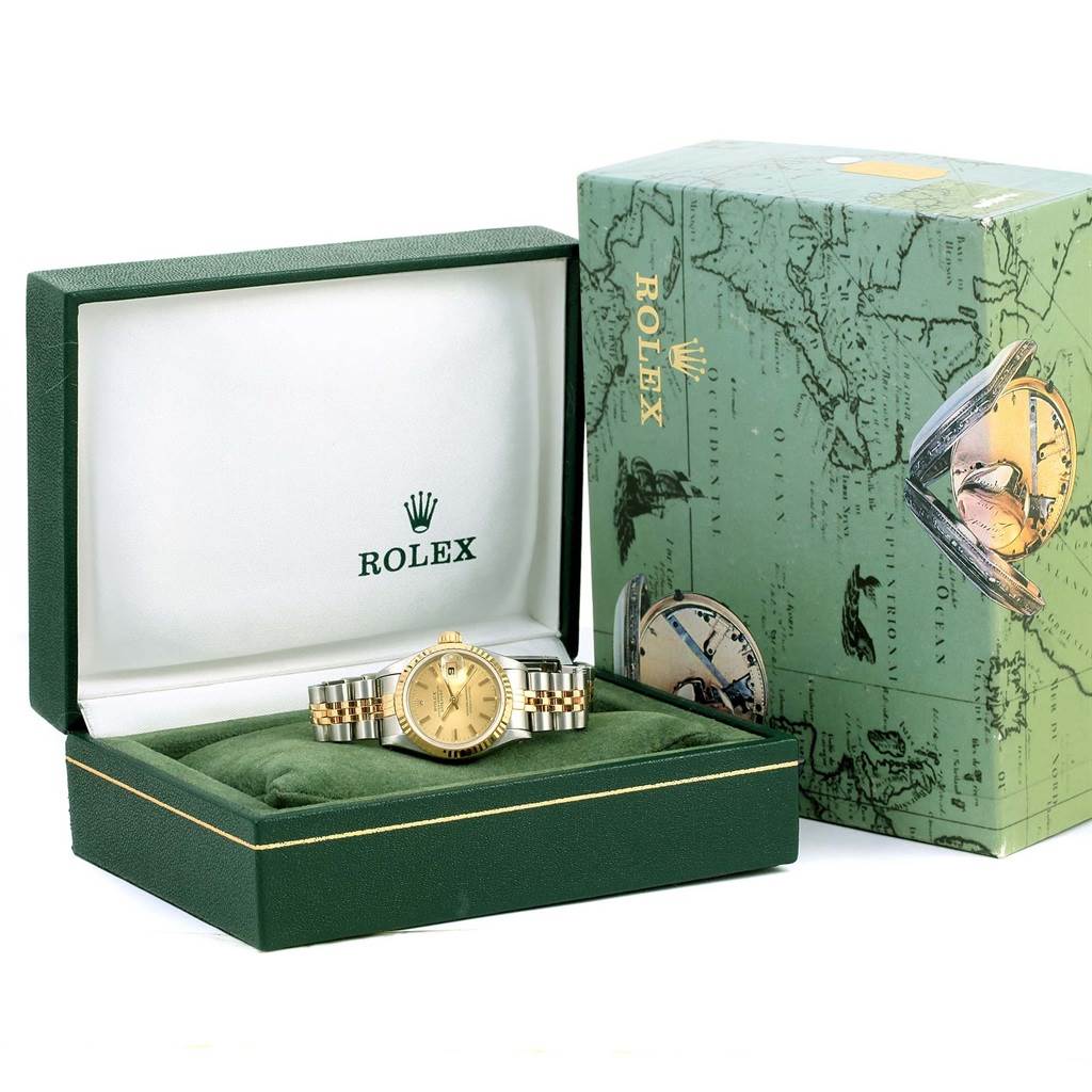 The Rolex Datejust 69173 Women's Stainless Steel Champagne Dial 69173 Women's Stainless Steel Champagne Dial watch is shown from the front in an open green box beside its outer box.