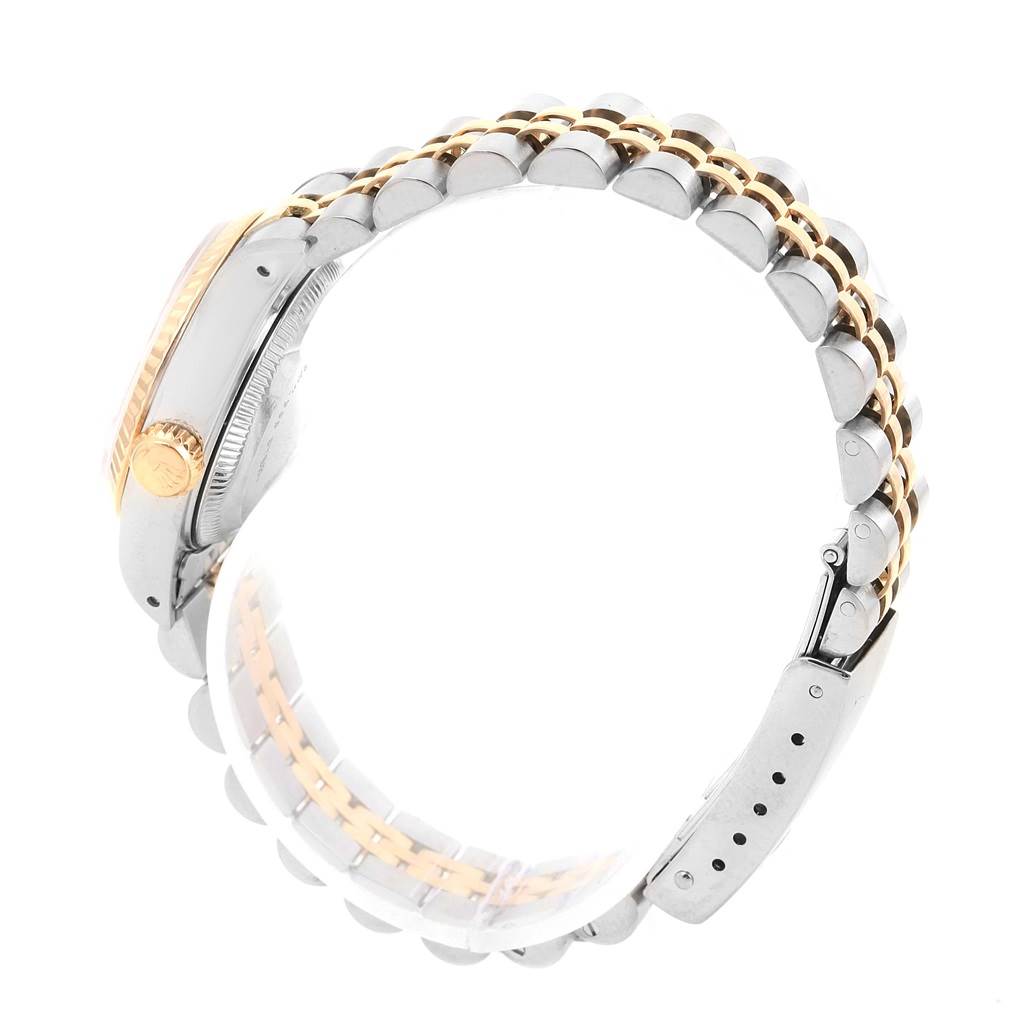 The image shows a Rolex Datejust 69173 Women's Stainless Steel White Dial 69173 Women's Stainless Steel White Dial watch from a side angle, highlighting its crown, fluted bezel, and Jubilee bracelet.