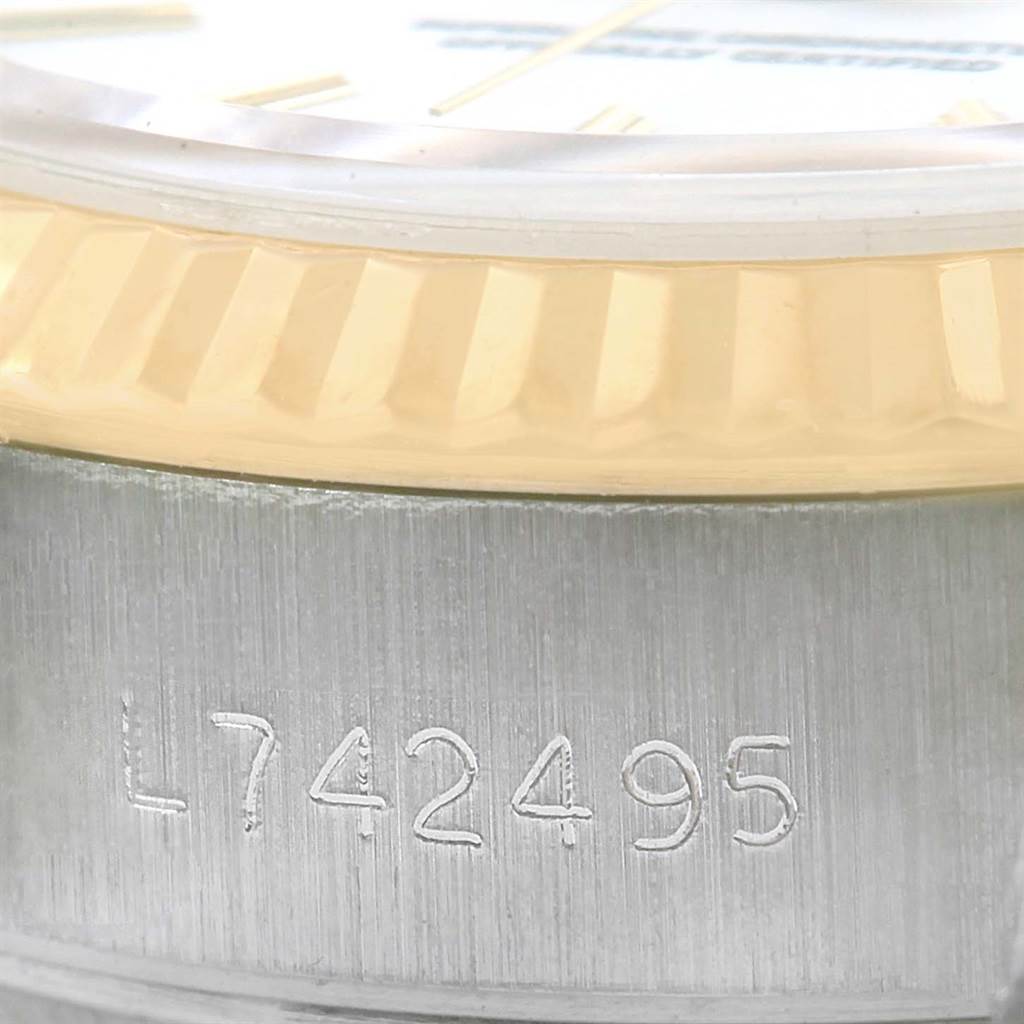 This close-up image of a Rolex Datejust 69173 Women's Stainless Steel White Dial 69173 Women's Stainless Steel White Dial watch shows the serial number engraved on the side of the case and part of the bezel.