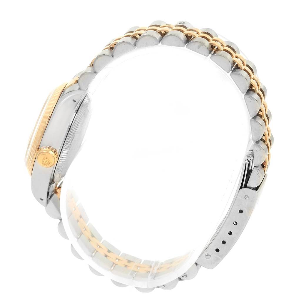 The image shows a side view of a Rolex Datejust 69173 Women
s Stainless Steel Champagne Dial 69173 Women
s Stainless Steel Champagne Dial watch, highlighting the case and Jubilee bracelet with two-tone links.