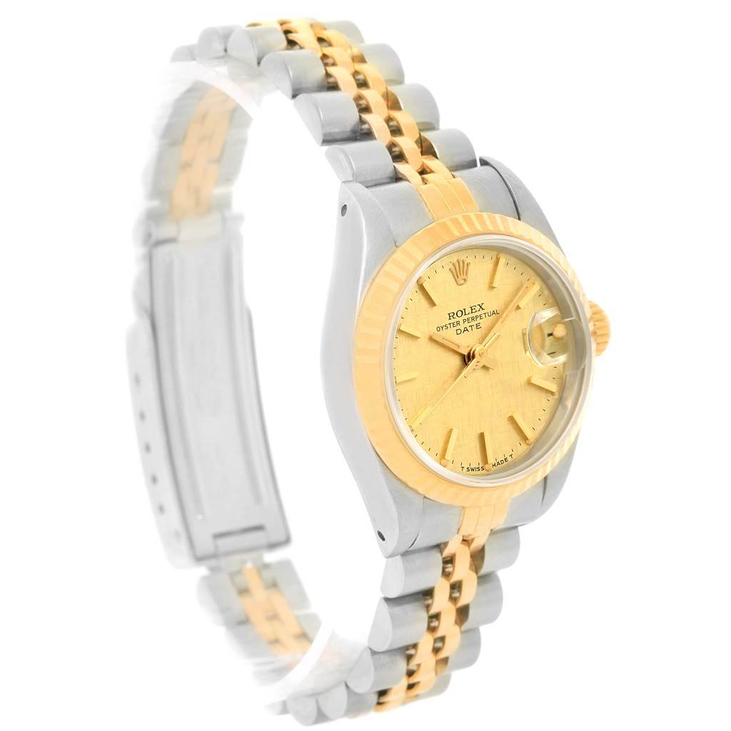 The image shows a side angle of a Rolex Datejust 69173 Women
s Stainless Steel Champagne Dial 69173 Women
s Stainless Steel Champagne Dial watch, displaying the bezel, dial, crown, and two-tone bracelet.