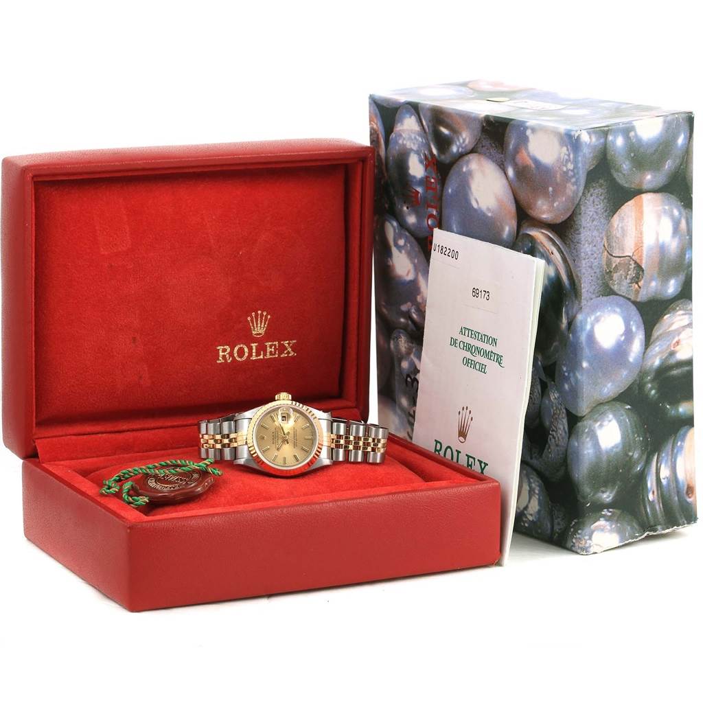 The image shows a Rolex Datejust 69173 Women
s Stainless Steel Champagne Dial 69173 Women
s Stainless Steel Champagne Dial watch, displayed in its open red case with accompanying documentation and tags.