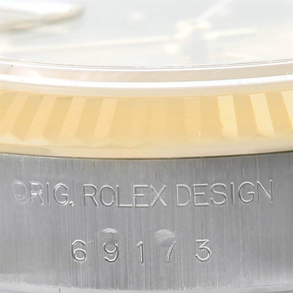 This is a close-up angle showing the side engraving and bezel of a Rolex Datejust 69173 Women
s Stainless Steel Champagne Dial 69173 Women
s Stainless Steel Champagne Dial watch.