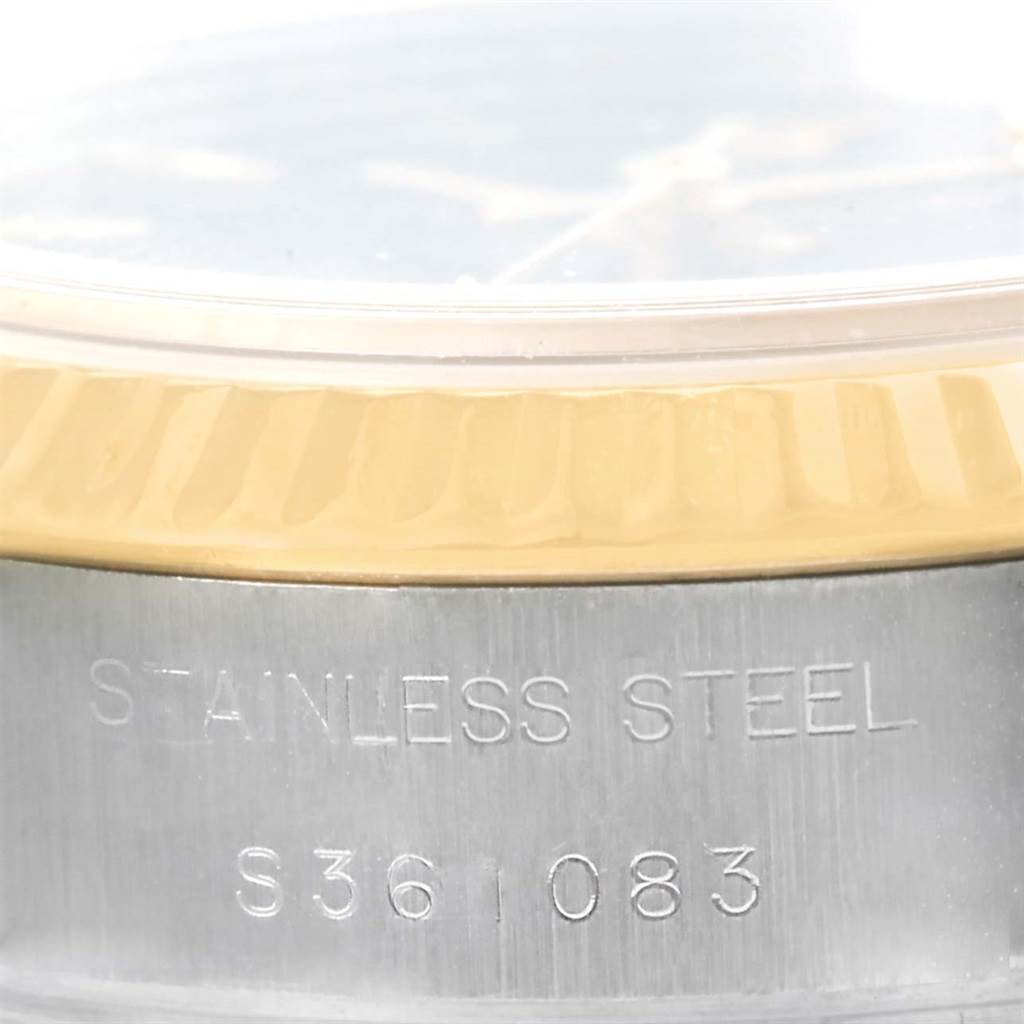 This close-up angle shows the case side of a Rolex Datejust 69173 Women
s Stainless Steel Black Dial 69173 Women
s Stainless Steel Black Dial watch, highlighting the "STAINLESS STEEL" engraving and serial number.