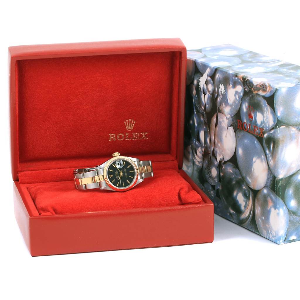 The Rolex Datejust 69173 Women
s Stainless Steel Black Dial 69173 Women
s Stainless Steel Black Dial watch is shown from the front, displayed in a red box with its outer patterned box beside it.