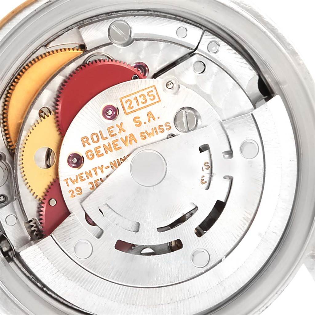 This image shows a close-up view of the internal mechanism of a Rolex Datejust 69173 Women's Stainless Steel Black Dial 69173 Women's Stainless Steel Black Dial watch, highlighting the gears and movement.