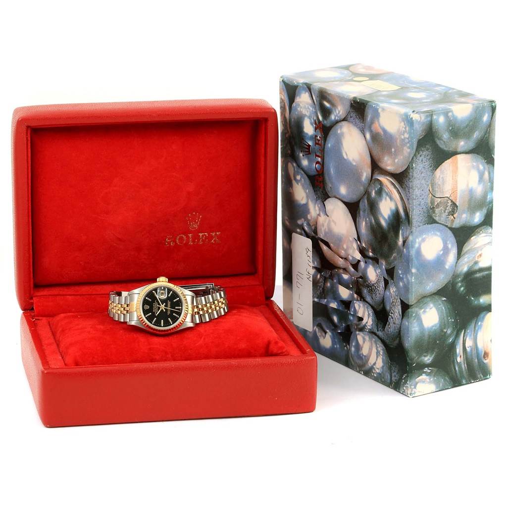 The image shows a Rolex Datejust 69173 Women's Stainless Steel Black Dial 69173 Women's Stainless Steel Black Dial watch, displayed inside an open red box with its packaging beside it.