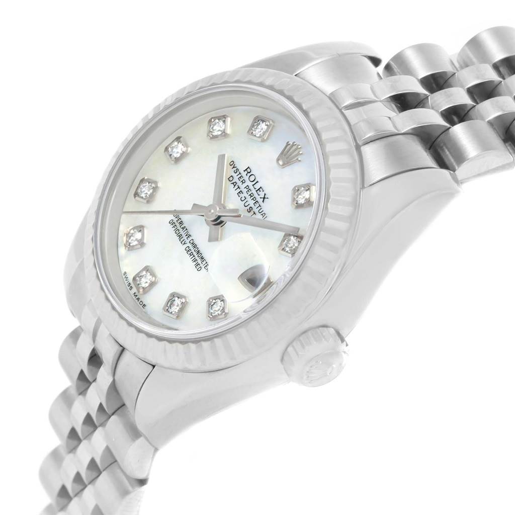 The image shows a Rolex Datejust 179174 Women
s Stainless Steel Mother of Pearl Dial 179174 Women
s Stainless Steel Mother of Pearl Dial watch from a side angle, highlighting its dial, fluted bezel, crown, and part of the bracelet.