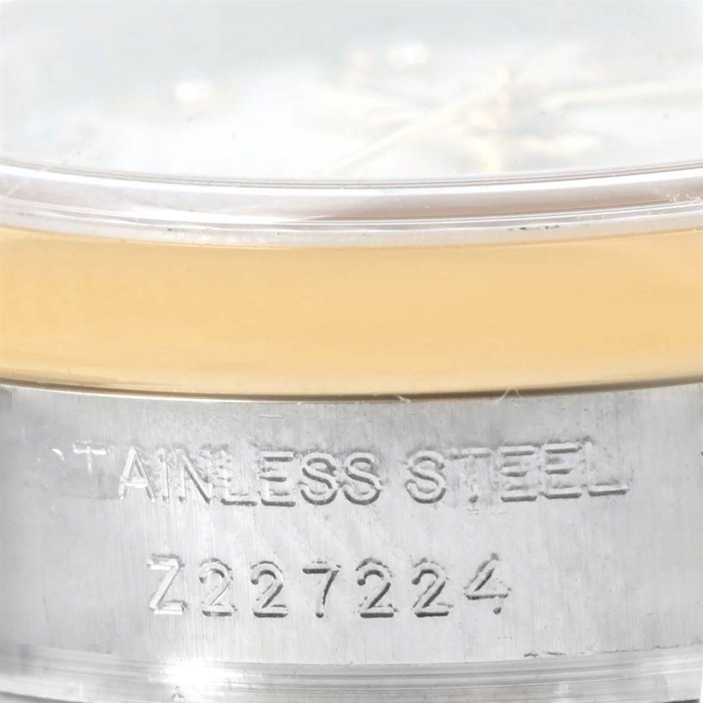 The image shows the side of a Rolex Datejust 179163 Women's Steel and Gold (two tone) Champagne Dial 179163 Women's Steel and Gold (two tone) Champagne Dial watch focusing on its stainless steel case and serial number.