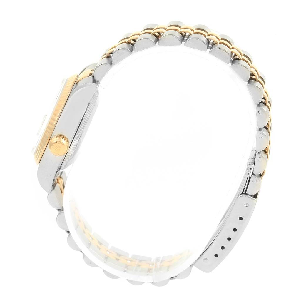 The image shows a side view of a Rolex Datejust 69173 Women's Stainless Steel Grey Dial 69173 Women's Stainless Steel Grey Dial watch, highlighting its gold crown, two-tone case, and bracelet.