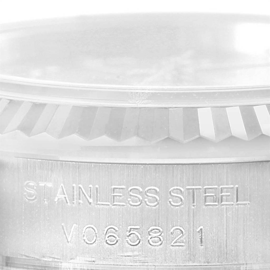 The image shows a close-up of the stainless steel case and fluted bezel of a Rolex Datejust 179174 Women's Stainless Steel Pink Dial 179174 Women's Stainless Steel Pink Dial watch.