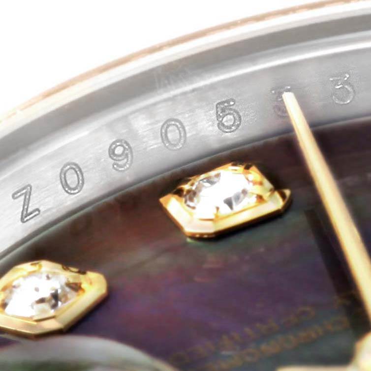 This close-up view of the Rolex Datejust 179163 Women's Steel and Gold (two tone) Mother of Pearl Dial 179163 Women's Steel and Gold (two tone) Mother of Pearl Dial watch displays the serial number on the watch case and diamond markers on the dial.