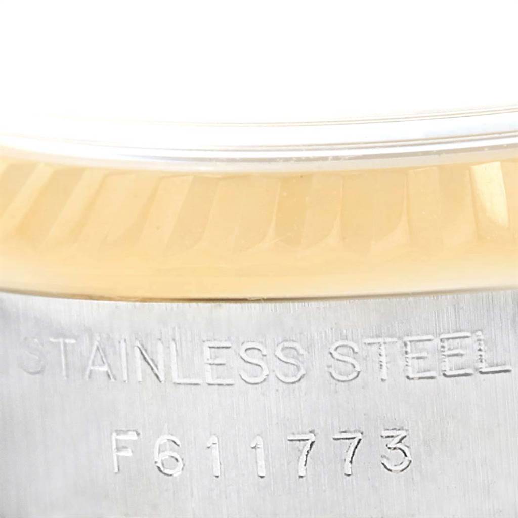 This image shows a close-up of the stainless steel engraving and part of the fluted bezel on a Rolex Datejust 179173 Women's Steel and Gold (two tone) Champagne Dial 179173 Women's Steel and Gold (two tone) Champagne Dial watch.