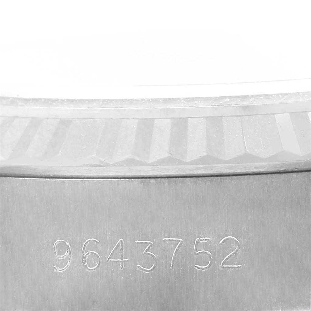 The image shows the serial number and fluted bezel of a Rolex Datejust 69174 Women's Stainless Steel Silver Dial 69174 Women's Stainless Steel Silver Dial watch from a close-up angle.