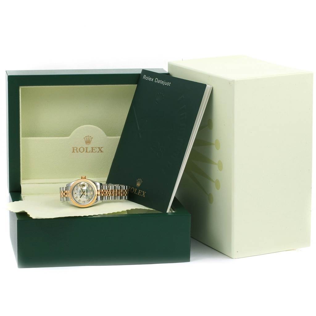 The image shows a Rolex Datejust 179173 Women's Steel and Gold (two tone) Mother of Pearl Dial 179173 Women's Steel and Gold (two tone) Mother of Pearl Dial watch in its open green box, accompanied by its booklet and outer packaging.