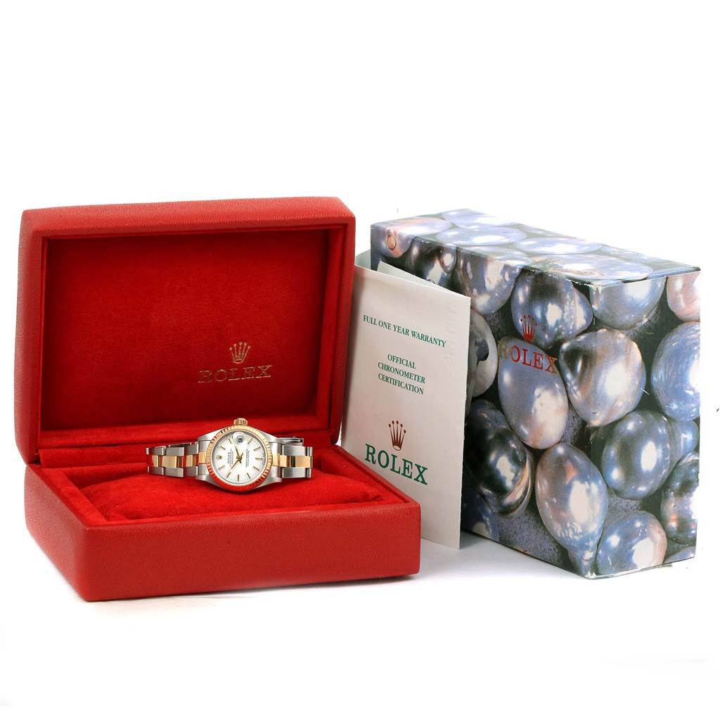 The Rolex Datejust 79173 Women's Steel and Gold (two tone) White Dial 79173 Women's Steel and Gold (two tone) White Dial watch is displayed at an angle inside its red box, accompanied by documentation and an outer box.