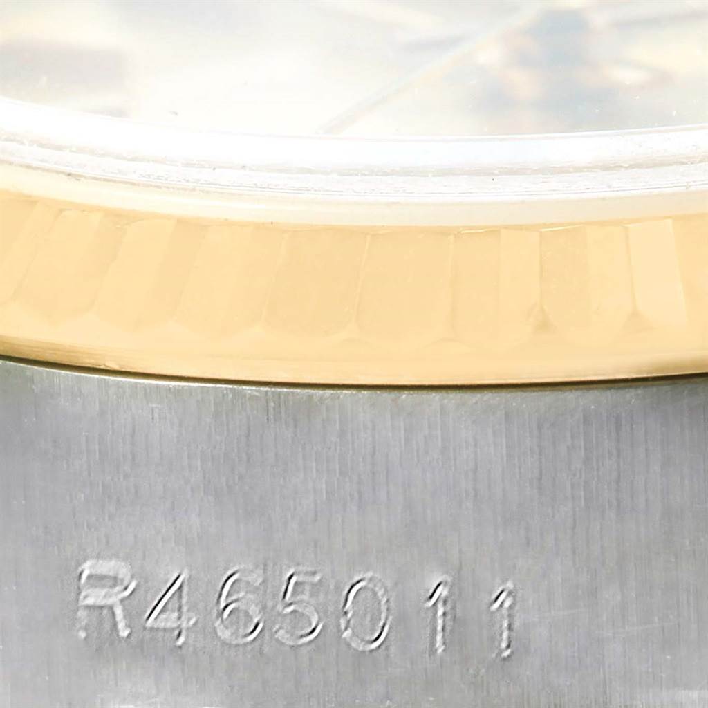 The close-up image shows part of the bezel and case of a Rolex Datejust 69173 Women's Stainless Steel Champagne Dial 69173 Women's Stainless Steel Champagne Dial watch with a partial serial number.