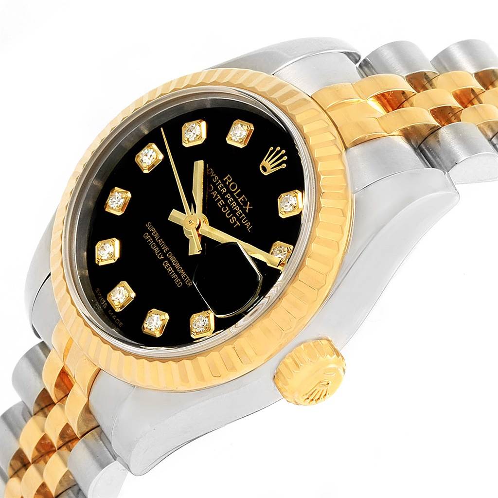 The image shows the face, crown, and part of the bracelet of a Rolex Datejust 179173 Women's Steel and Gold (two tone) Black Dial 179173 Women's Steel and Gold (two tone) Black Dial watch at a slight angle.